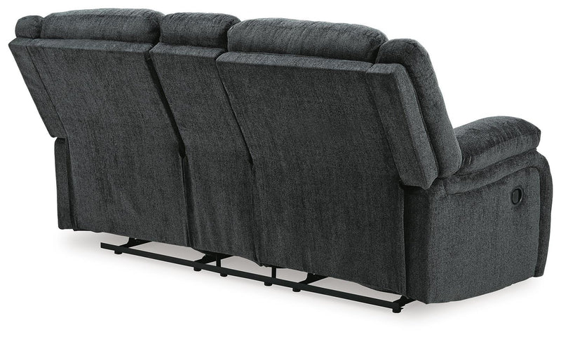 Ashley Furniture Draycoll reclining loveseat with built-in console, shown from the back with plush fabric and cushioned armrests.