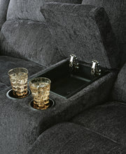 Ashley Furniture Draycoll reclining loveseat with console, featuring plush upholstery, padded armrests, and built-in storage console.