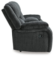 Ashley Furniture Draycoll reclining loveseat with console, showing plush fabric, padded armrests, and built-in cup holders.