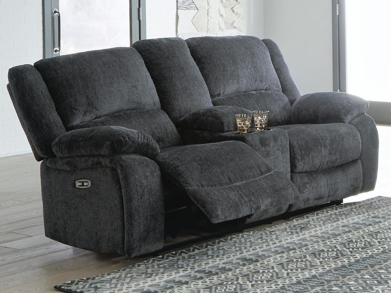 Ashley Furniture Draycoll power reclining loveseat with console, showing plush fabric and built-in cup holders in a modern living room setting.