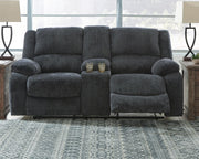 Ashley Furniture Draycoll reclining loveseat with console, featuring plush cushions and built-in cup holders, ideal for comfortable seating.