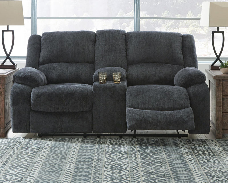 Ashley Furniture Draycoll reclining loveseat with console, featuring plush cushions and built-in cup holders, ideal for comfortable seating.