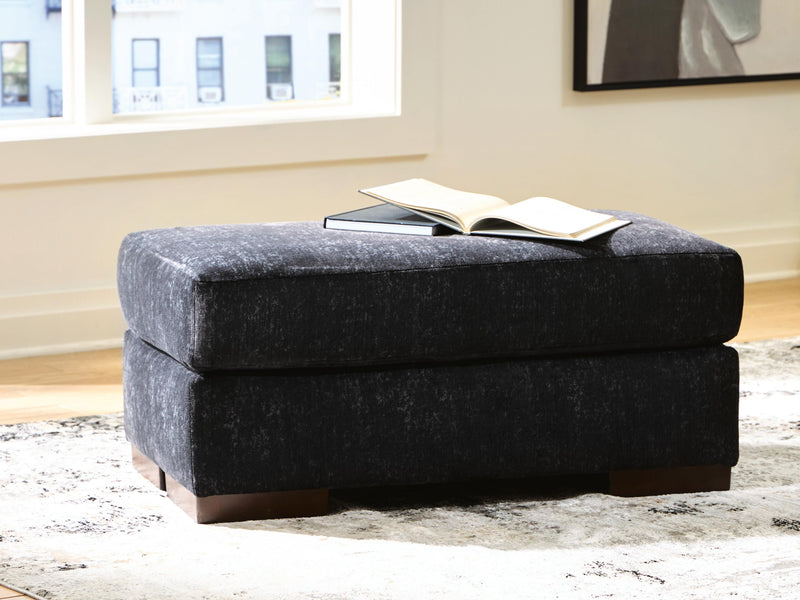 Ashley Furniture Whitmore Manor Ottoman, rectangular upholstered storage ottoman with tufted top and wooden base.