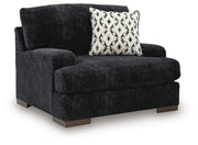 Ashley Furniture Whitmore Manor oversized chair with plush upholstery and wide armrests, shown from an angled side view.