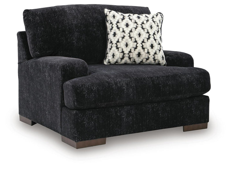 Ashley Furniture Whitmore Manor oversized chair with plush upholstery and wide armrests, shown from an angled side view.