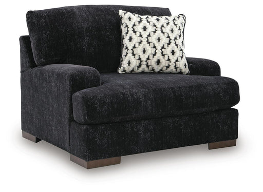 Ashley Furniture Whitmore Manor oversized chair with plush upholstery and wide armrests, shown from an angled side view.