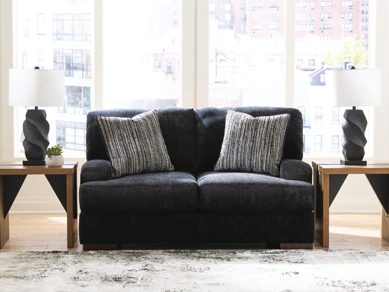 Ashley Furniture Whitmore Manor loveseat with plush fabric and elegant design, shown in a cozy living room setting.