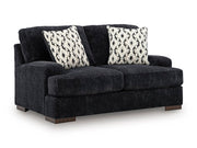 Ashley Furniture Whitmore Manor Loveseat with plush upholstery and elegant design, shown from an angled view.