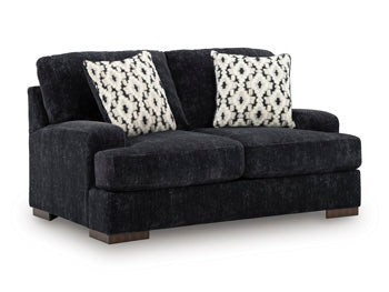 Ashley Furniture Whitmore Manor Loveseat with plush upholstery and elegant design, shown from an angled view.