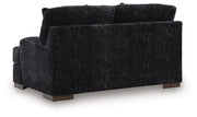Ashley Furniture Whitmore Manor loveseat with plush fabric and elegant design, shown from the back view.