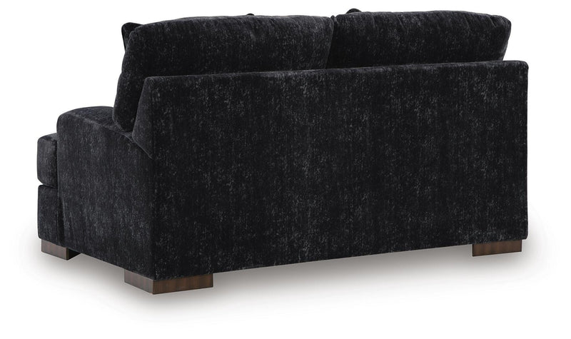 Ashley Furniture Whitmore Manor loveseat with plush fabric and elegant design, shown from the back view.