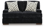 Ashley Furniture Whitmore Manor loveseat showing plush fabric, rolled arms, and cozy seating in a classic living room setting.