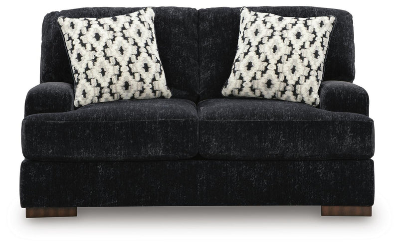 Ashley Furniture Whitmore Manor loveseat showing plush fabric, rolled arms, and cozy seating in a classic living room setting.