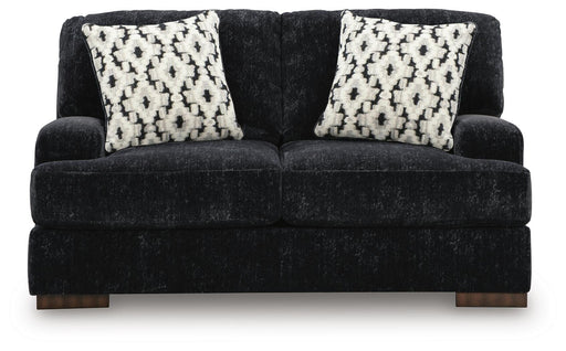 Ashley Furniture Whitmore Manor loveseat showing plush fabric, rolled arms, and cozy seating in a classic living room setting.