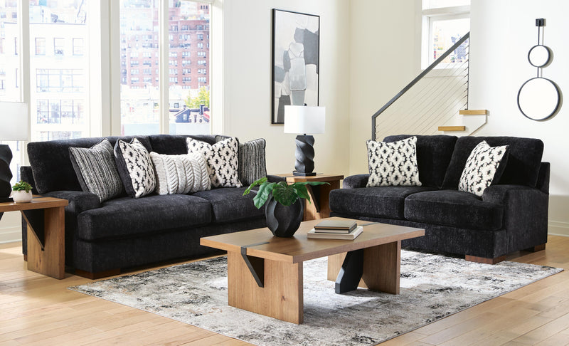 Ashley Furniture Whitmore Manor living room set with sofa and armchair, featuring neutral upholstery and wooden accents.