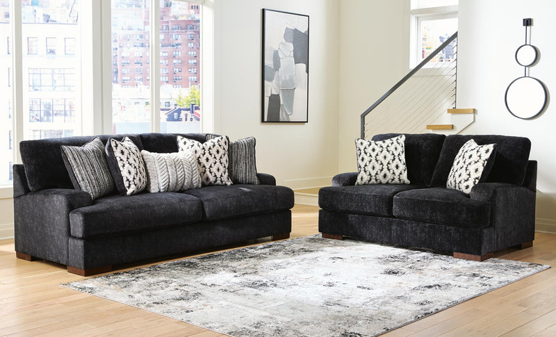 Ashley Furniture Whitmore Manor living room set with plush sofa, armchair, and matching coffee table in a stylish living space.