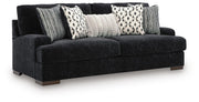 Ashley Furniture Whitmore Manor sofa shown from an angled side view, featuring plush cushions and elegant upholstery.