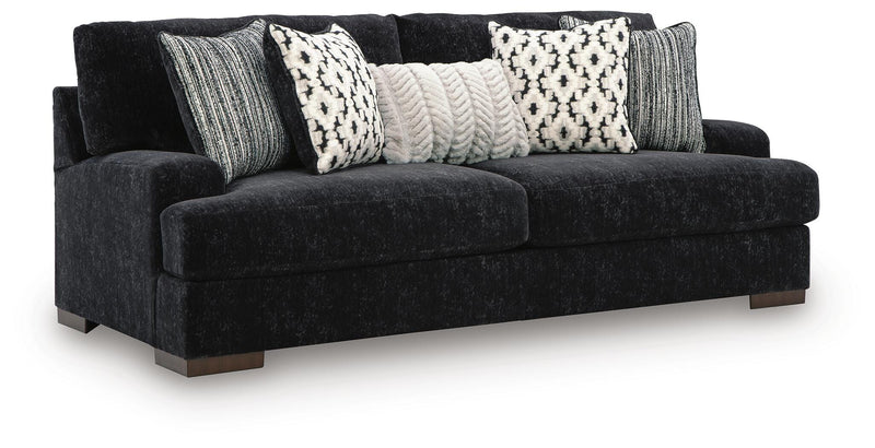 Ashley Furniture Whitmore Manor sofa shown from an angled side view, featuring plush cushions and elegant upholstery.