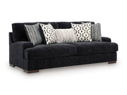 Ashley Furniture Whitmore Manor sofa shown from an angle, featuring plush cushions and classic design in a cozy living room setting.