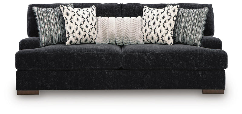 Ashley Furniture Whitmore Manor living room set featuring a sofa and armchair with neutral upholstery and wooden legs.