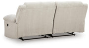 Ashley Furniture Orlen reclining sofa with plush cushions and fabric upholstery, shown from the back view.