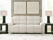 Ashley Furniture Orlen reclining sofa with plush cushions and dark upholstery, shown in a close-up view.