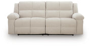 Ashley Furniture Orlen reclining sofa shown from head-on, featuring plush cushions and a modern design in a neutral fabric.