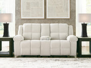 Ashley Furniture Orlen reclining loveseat with console, featuring plush fabric, padded armrests, and built-in center console.