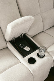 Ashley Furniture Orlen reclining loveseat with console, featuring plush fabric, padded armrests, and integrated cup holders.