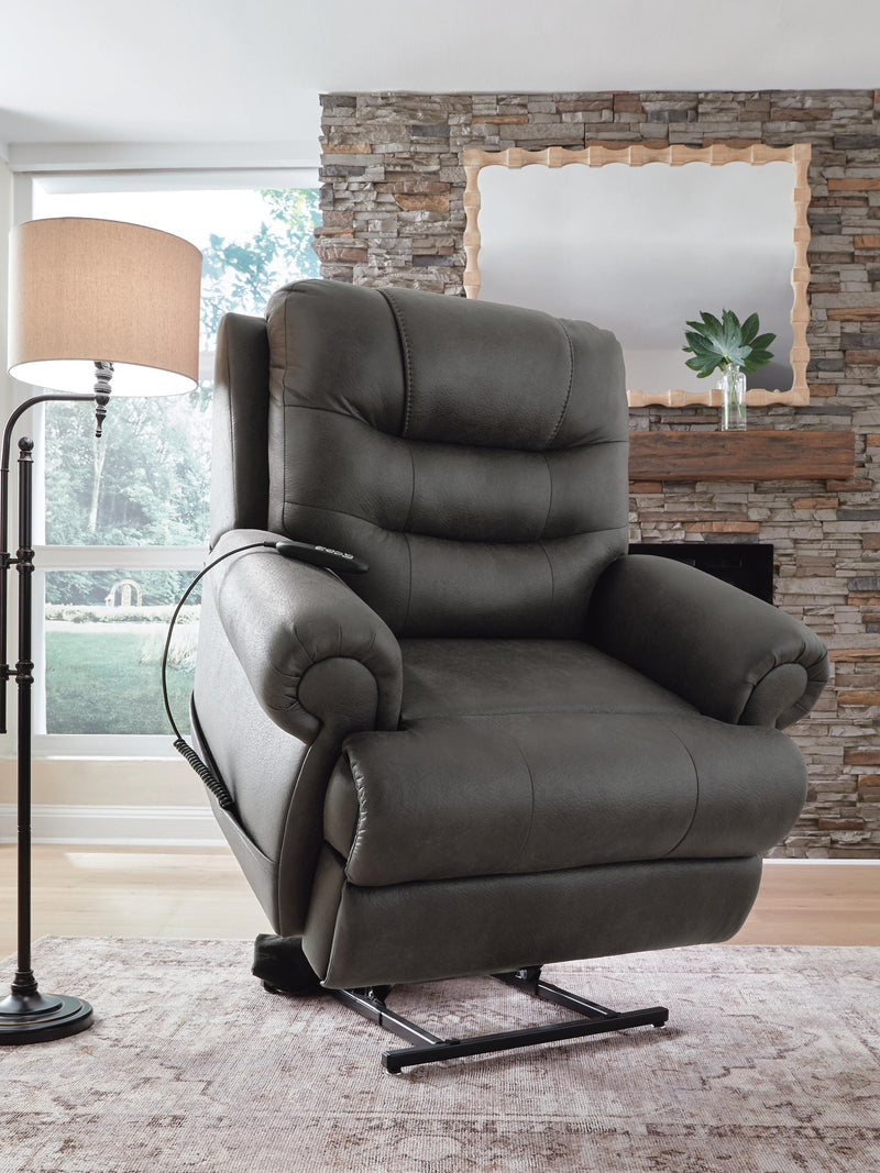 Ashley Furniture power lift recliner in plush fabric, showing the side angle with footrest extended and back reclined.