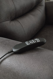 Ashley Furniture power lift recliner in dark leather, showing plush cushioning and adjustable reclining features.