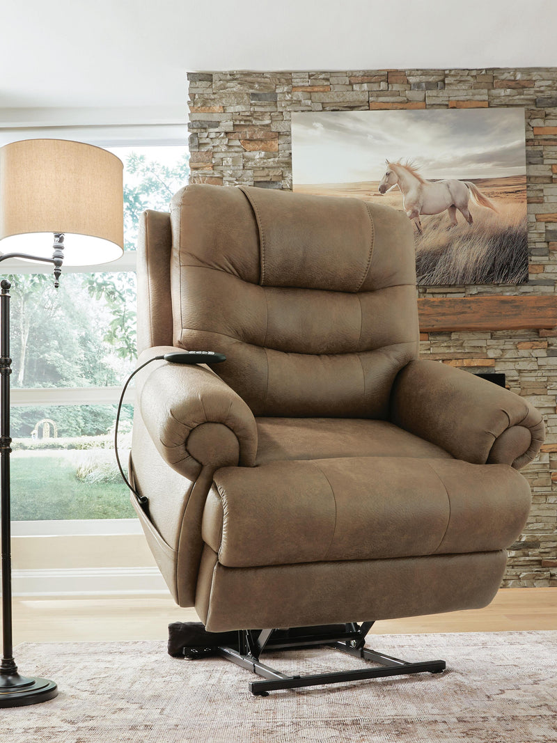 Ashley Furniture power lift recliner in beige fabric, showing the reclined position and padded armrests from an angled view.