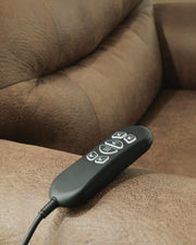 Ashley Furniture power lift recliner in beige fabric with plush cushioning and wooden base, designed for comfort and support.