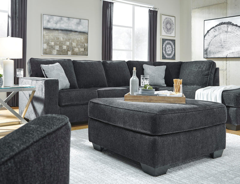 Ashley Furniture Altari oversized accent ottoman with plush fabric and tufted top, perfect for living room decor.