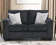 Ashley Furniture Altari loveseat with plush upholstery and cushioned backrest, shown in a cozy living room setting.