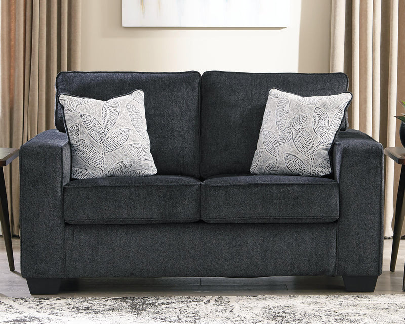 Ashley Furniture Altari loveseat with plush upholstery and cushioned backrest, shown in a cozy living room setting.