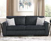 Ashley Furniture Altari living room set with sofa, love seat, and armchair in neutral upholstery, arranged in a cozy modern design.