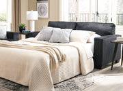 Ashley Furniture Altari sofa sleeper with plush fabric, featuring a convertible design and comfortable seating in a modern living room setting.