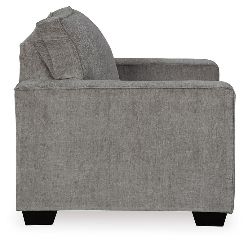 Ashley Furniture Altari Chair with beige upholstery and wooden legs, shown from a side angle in a modern living room setting.