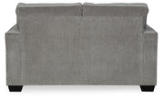 Ashley Furniture Altari loveseat with plush fabric and cushioned backrest, shown from the back in a cozy living room setting.