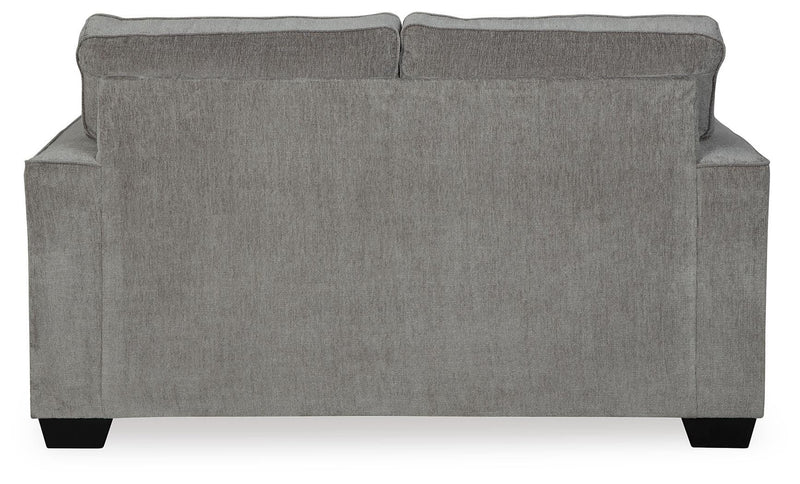 Ashley Furniture Altari loveseat with plush fabric and cushioned backrest, shown from the back in a cozy living room setting.