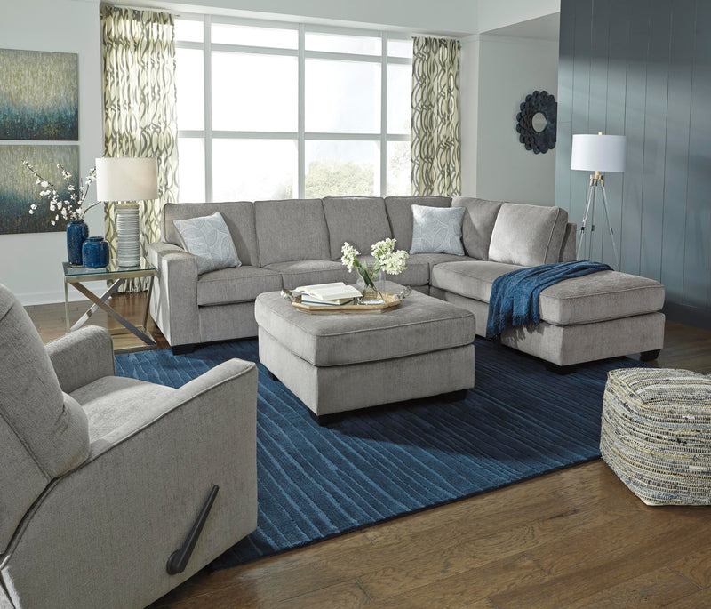 Ashley Furniture Altari sectional with chaise, cream fabric, modern design, and plush cushions in a stylish living room setting.