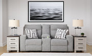 Ashley Furniture Biscoe Power Reclining Loveseat with plush cushions and reclining features in a modern living room setting.