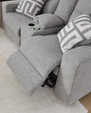 Ashley Furniture Biscoe Power Reclining Loveseat with plush cushions and reclining features in a modern living room setting.