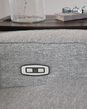 Ashley Furniture Biscoe power reclining loveseat with USB ports, featuring plush fabric and cushioned armrests.