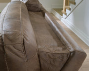 Ashley Furniture Beckley Place power reclining sofa with plush cushions and dark upholstery, shown in a living room setting.