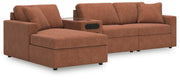 Ashley Furniture Modmax sectional with chaise, featuring plush cushions and modern design in a cozy living room setting.