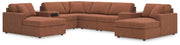 Ashley Furniture Modmax sectional with chaise, featuring plush upholstery and modern design, shown in a cozy living room setting.
