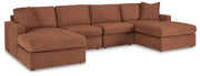 Ashley Furniture Modmax sectional with chaise, featuring plush cushions and modern design in a cozy living room setting.