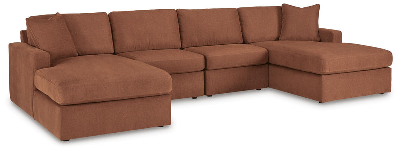 Ashley Furniture Modmax sectional with chaise, featuring plush cushions and modern design in a cozy living room setting.